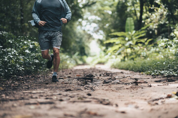 healthy lifestyle young fitness man running the forest. Outdoor workout,  Healthy lifestyle concept.