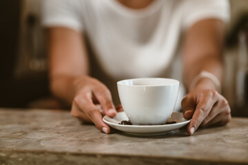 Barista serving a coffee to customer at the coffee shop.
