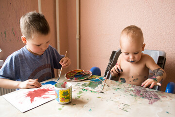 Children draw with paints. baby in paint.