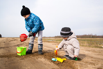 Children play in the sand in nature.