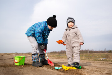 Children play in the sand in nature.