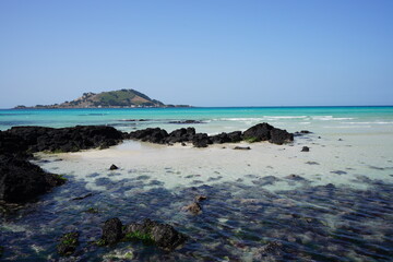 rock beach and distant island