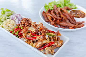 Fototapeta premium Fried Sun-Dried Pork and Fermented Pork Delicious hands on the table