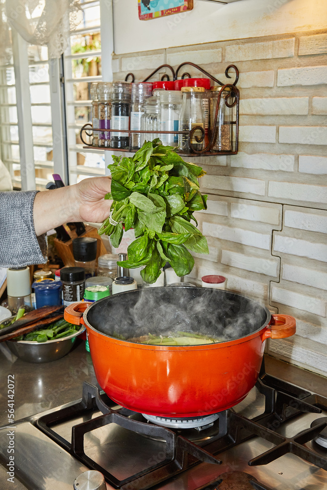 Sticker Chef blanched bunch of basil in simmering pot