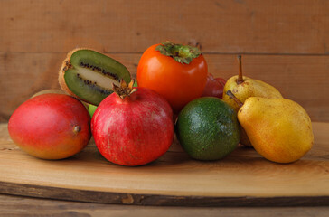 Group of fruits of yellow, red and green shades on a wooden table. Fresh fruits.