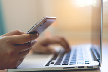 Woman using mobile phone to pay online shopping at home