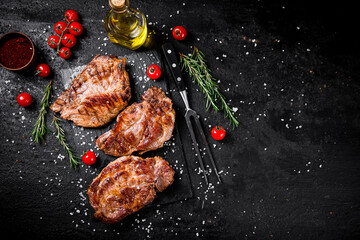 Grilled pork steak with cherry tomatoes and rosemary.  - 564144842