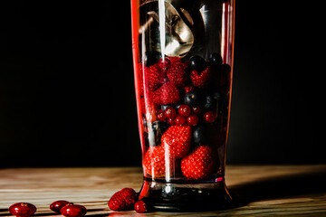 Fruit in a blender, mixer. Fruit cocktail and healthy food and drinks. Strawberry, raspberry,...