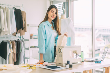 Asian woman designer busy making clothes work or study in fashion design studio