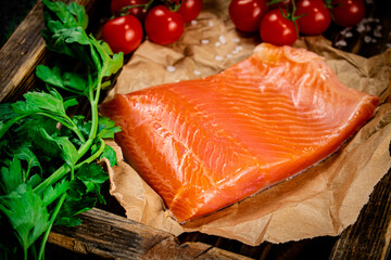 A large piece of salted salmon on a wooden tray. 