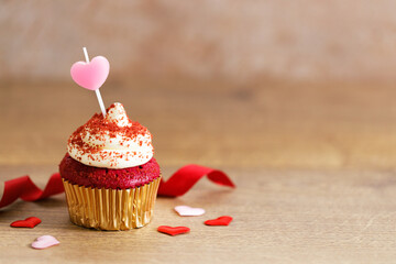 red velvet cupcake top with white cream cheese frosting.