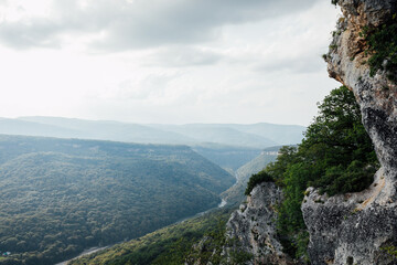 view of the sky in the clouds from a green mountain