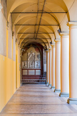 Narrow city street view traditional architectural features in Bologna, Italy