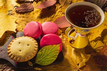 Still life- autumn motif. Bright culinary products, yellow leaves and a cup of tea