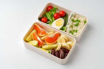 Lunch boxes with healthy food isolated on white