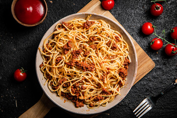 Delicious spaghetti bolognese in a bowl with cherry tomatoes. 
