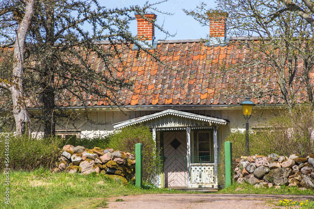 Sticker Idyllic wooden cottage at spring