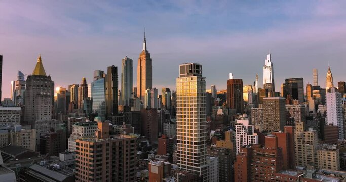 Aerial shot of NYC rising above buildings in Midtown Manhattan Skyline during beautiful sunrise sky