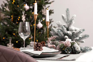 Luxury place setting with beautiful festive decor for Christmas dinner on white table