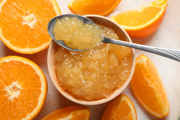 Fototapeta na wymiar Bowl of delicious orange jam and fresh fruits on plate, top view