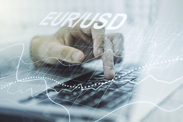 Creative concept of EURO USD financial chart illustration and hands typing on laptop on background. Trading and currency concept. Multiexposure