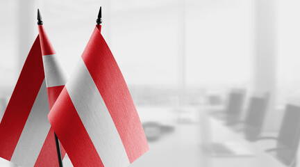 Small flags of the Austria on an abstract blurry background