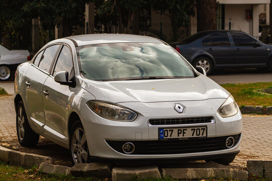 Side, Turkey -January 21, 2023:      white Renault Fluence   is parked  on the street on a warm summer day