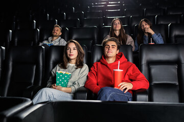 People drink lemonade and eat popcorn at a movie premiere at the cinema