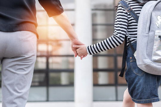 Back To School Education Concept With Girl Kid (elementary Student) Carrying Backpacks Holding Parent Woman Or Mother's Hand Walking Up School Building Stair Going To Class