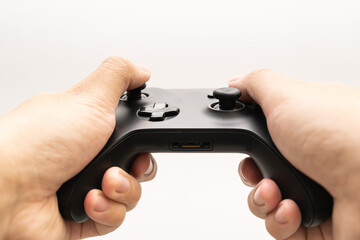 Black joystick in hands isolated on white background. Computer gaming technology play competition video game control confrontation concept. esport concept. © Wongsakorn