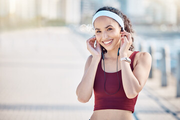 Fitness, portrait and woman with music at promenade, marathon training and wellness in Miami. Sports, happy athlete and outdoor runner with earphones for running exercise, cardio workout and sunshine - obrazy, fototapety, plakaty