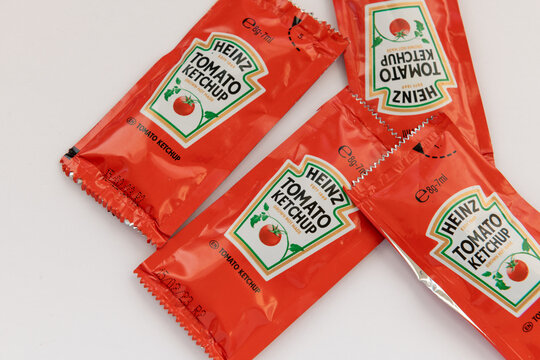 London. UK- 01.22.2023. Small packaged portions of Heinz tomato ketchup for the catering trade isolated in white.