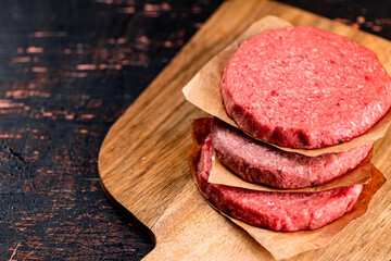 Raw burger on a cutting board. 