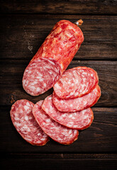 Sliced delicious salami sausage on the table. 