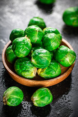 Fresh Brussels cabbage in a wooden plate. 
