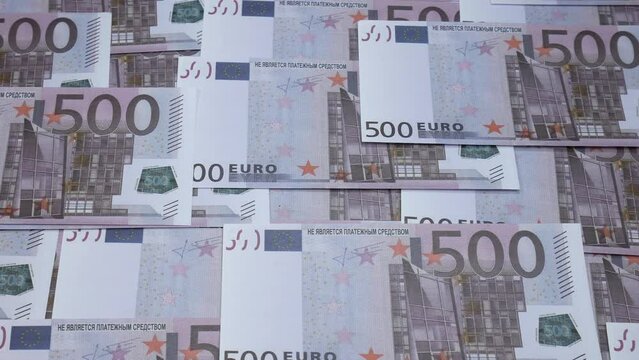 There are five hundred euros on the table. A lot of money fills the common people in the picture. European currency with a denomination of 500 euros.