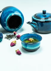 Foto op Aluminium Teapot and cups of Chinese tea on the table for the tea ceremony. Oriental tea set. The concept of a traditional Asian tea ceremony. Blue teapot and teacups on a gray background. Selective focus. © Nikita