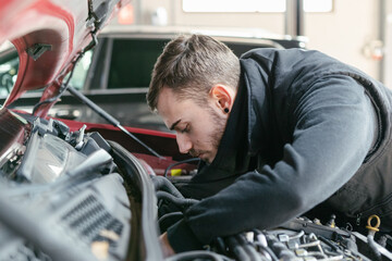 Fototapeta na wymiar Car mechanic working in a garage