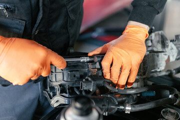 Car mechanic working in a garage