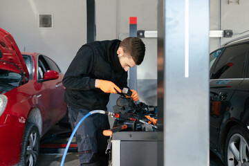 Car mechanic working in a garage