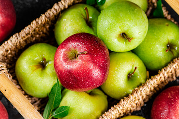 An assortment of red and green apples on the table. 