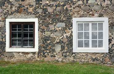 Windows on an old stone wall.