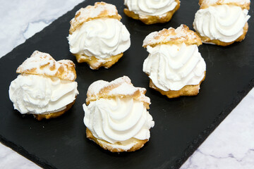 tray with six cream-filled cupcakes