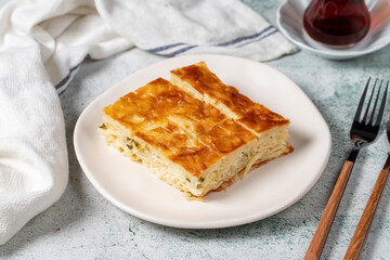 Turkish Su Boregi or Tabla borek with cheese. Turkish Patty on stone background. Close up