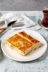 Turkish Su Boregi or Tabla borek with cheese. Turkish Patty on stone background. Close up