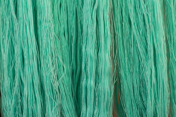 Green cotton thread background, textile industry concept, product of Thailand