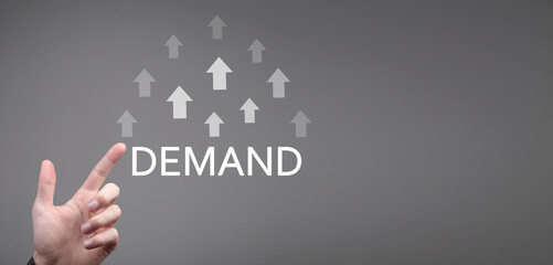 Male hand showing growing arrows and inscription Demand. Business