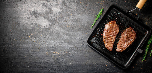 Delicious grilled steak in a frying pan. 