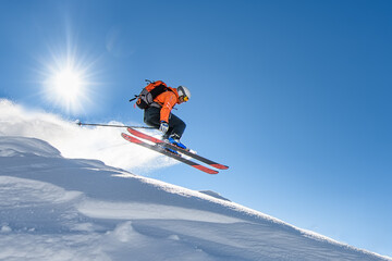 Fototapeta na wymiar Skier at speed flying through the sky