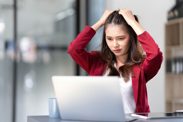 asian woman thinking hard concerned about online problem solution looking at laptop screen, worried serious asian businesswoman focused on solving difficult work computer task